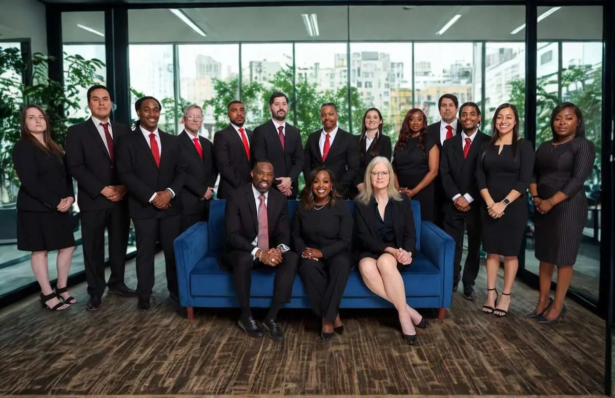 The L and L Law Group team at our Frisco, Texas office — co-founding partners Reggie London and Njeri London with staff